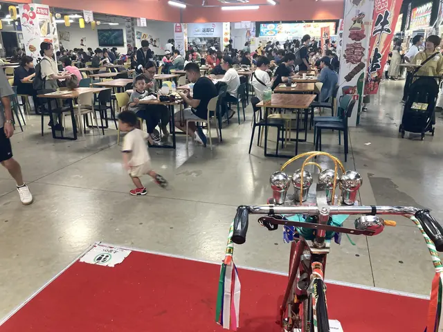 夕方のフードコート、装飾自転車越しの賑わい